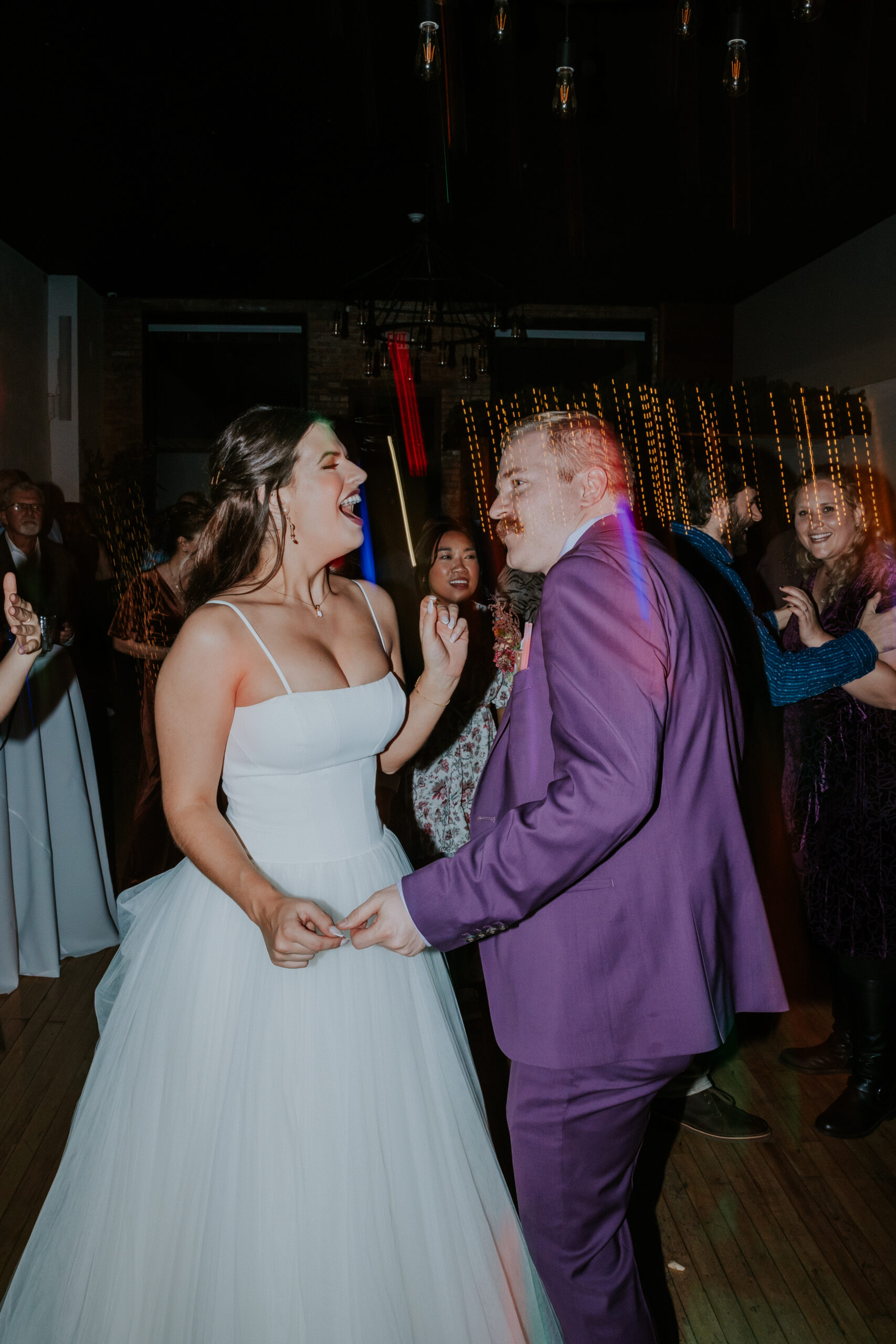 Couple dancing and laughing together during their wedding, captured by destination wedding photographers.
