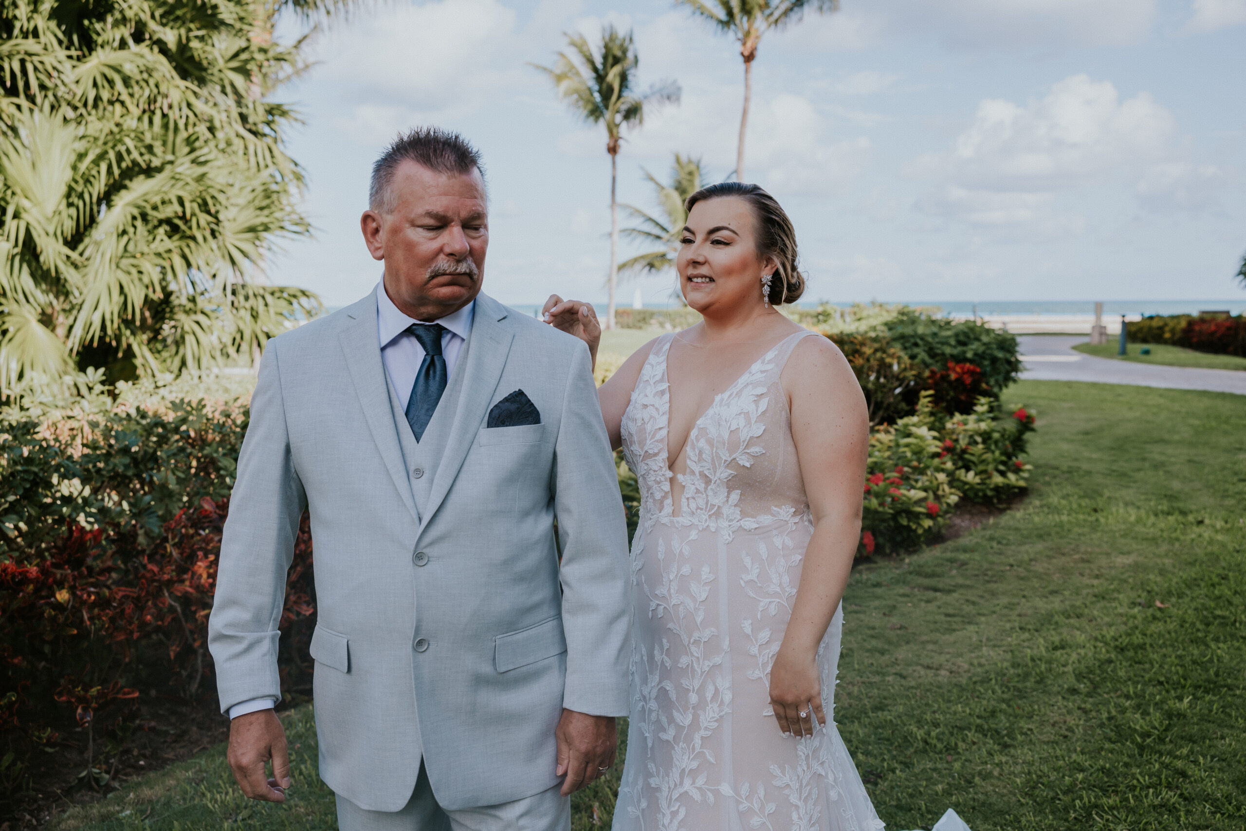 Emotional first look moment as the bride taps her father’s shoulder before he turns around to see her.