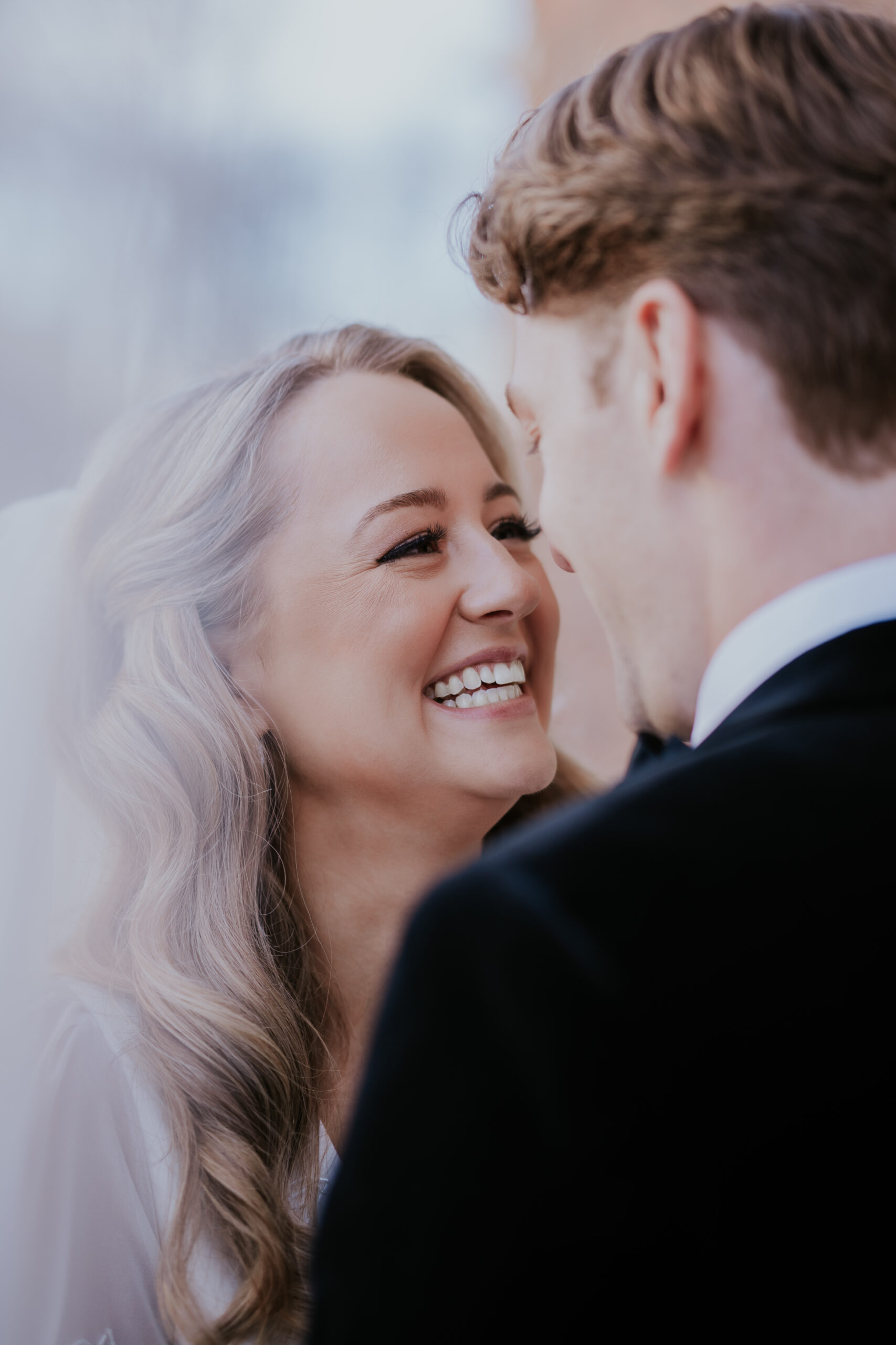 Close-up of the bride smiling at her groom during an intimate wedding moment.
