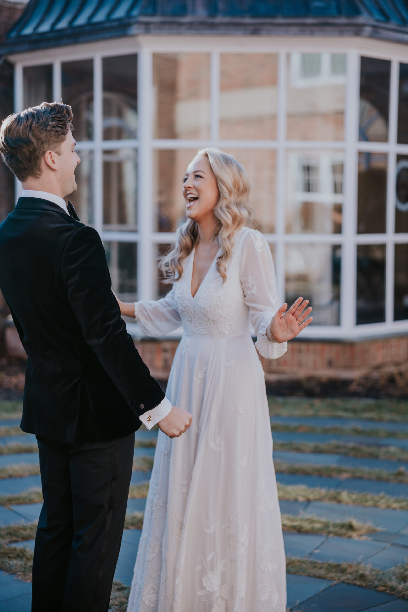 Bride laughing with her groom during a joyful first look, captured by a wedding photographer in Minnesota.