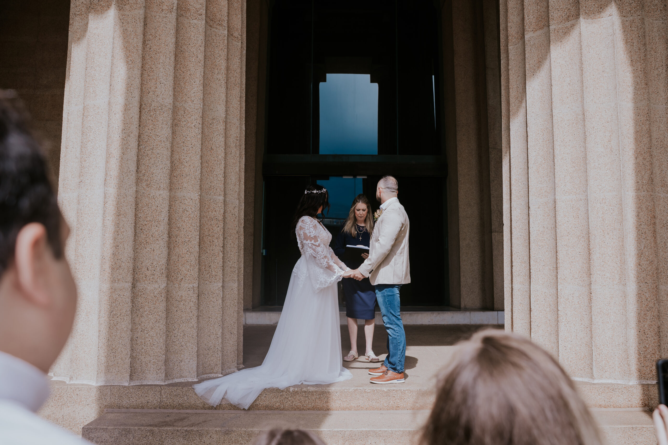 Bride and groom exchange vows in a simple yet powerful ceremony, beautifully documented by a travel wedding photographer.