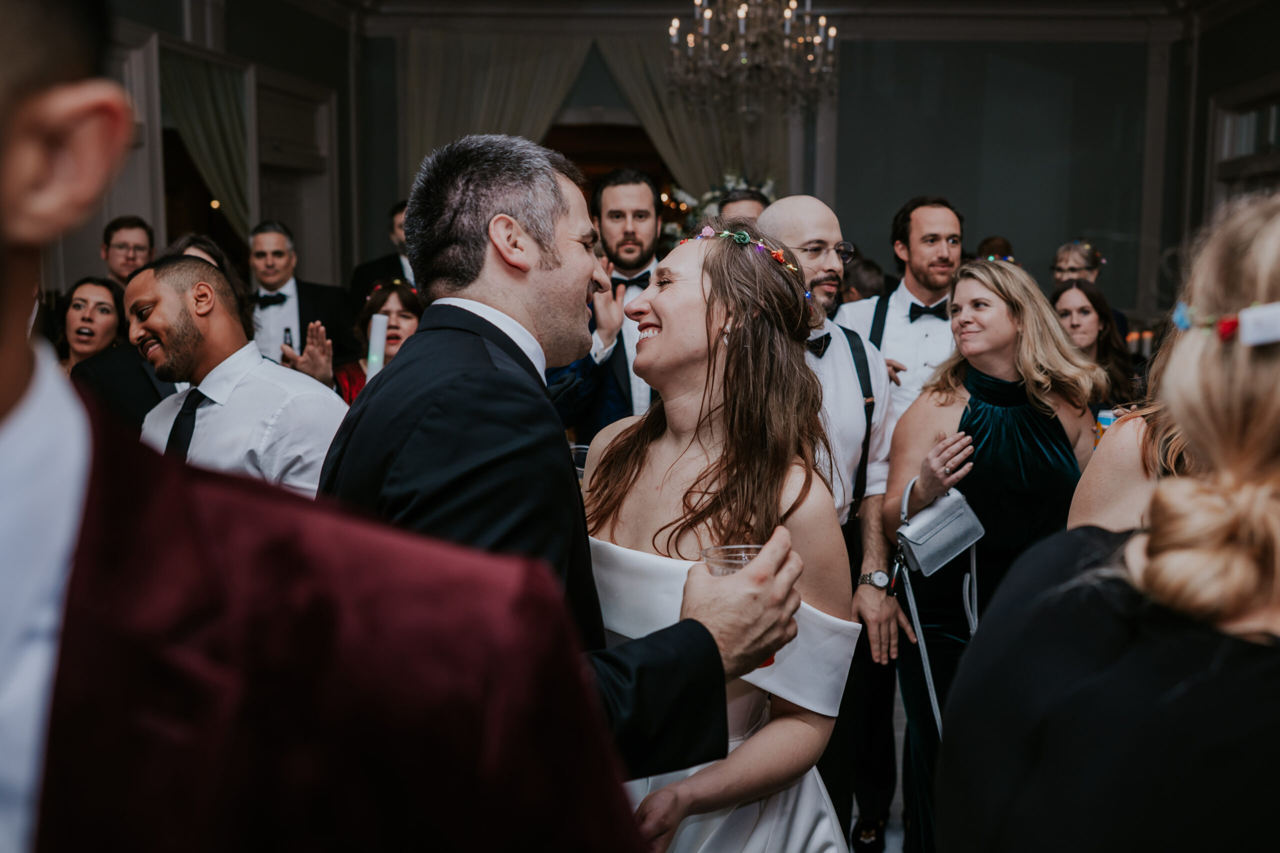 Amidst the crowd, the couple locks eyes and smiles during a sweet moment at their reception celebration.